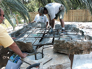 building rocks around pool