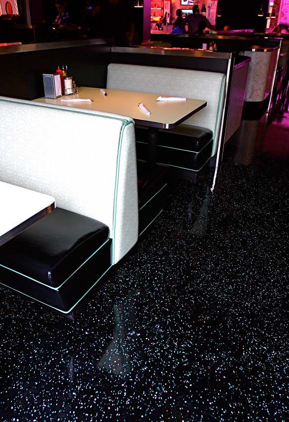 1950s style diner sporting shiny epoxy floors in pink, black and white.