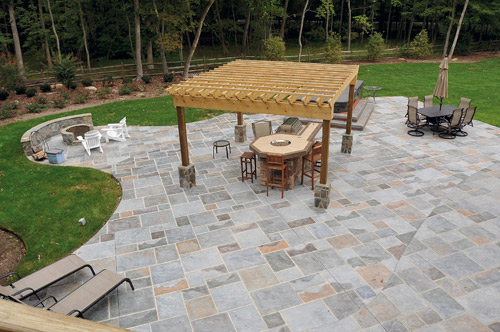 Stamped concrete patio and fire pit in muted slate colors.