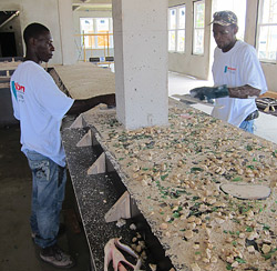 Sedding decorative aggregate - Workers seed and float in a large amount of decorative aggregate.