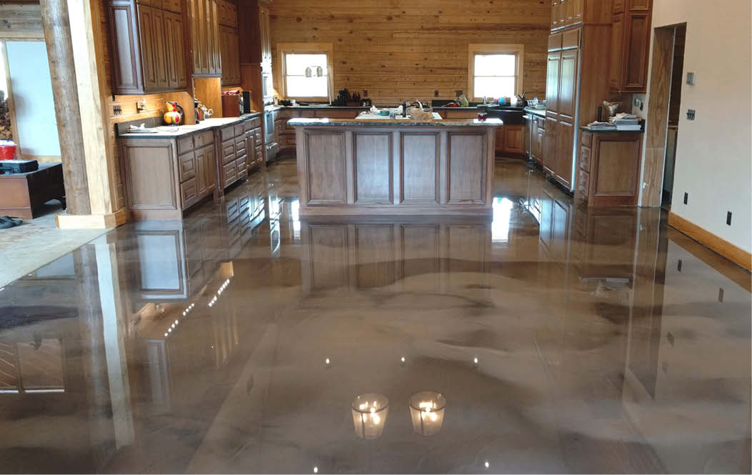 Brown and gray metallic concrete floor in a dining room and kitchen.