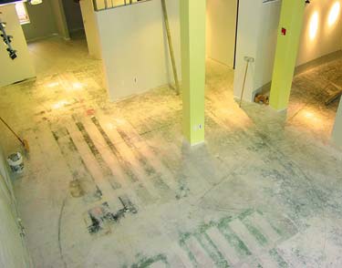 Process photo of a floor removal and then concrete staining job.