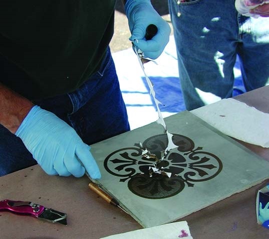 he stencil being removed from the surface of the concrete sample.