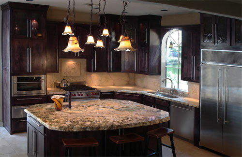 Kitchen with a countertop made of concrete and an island.