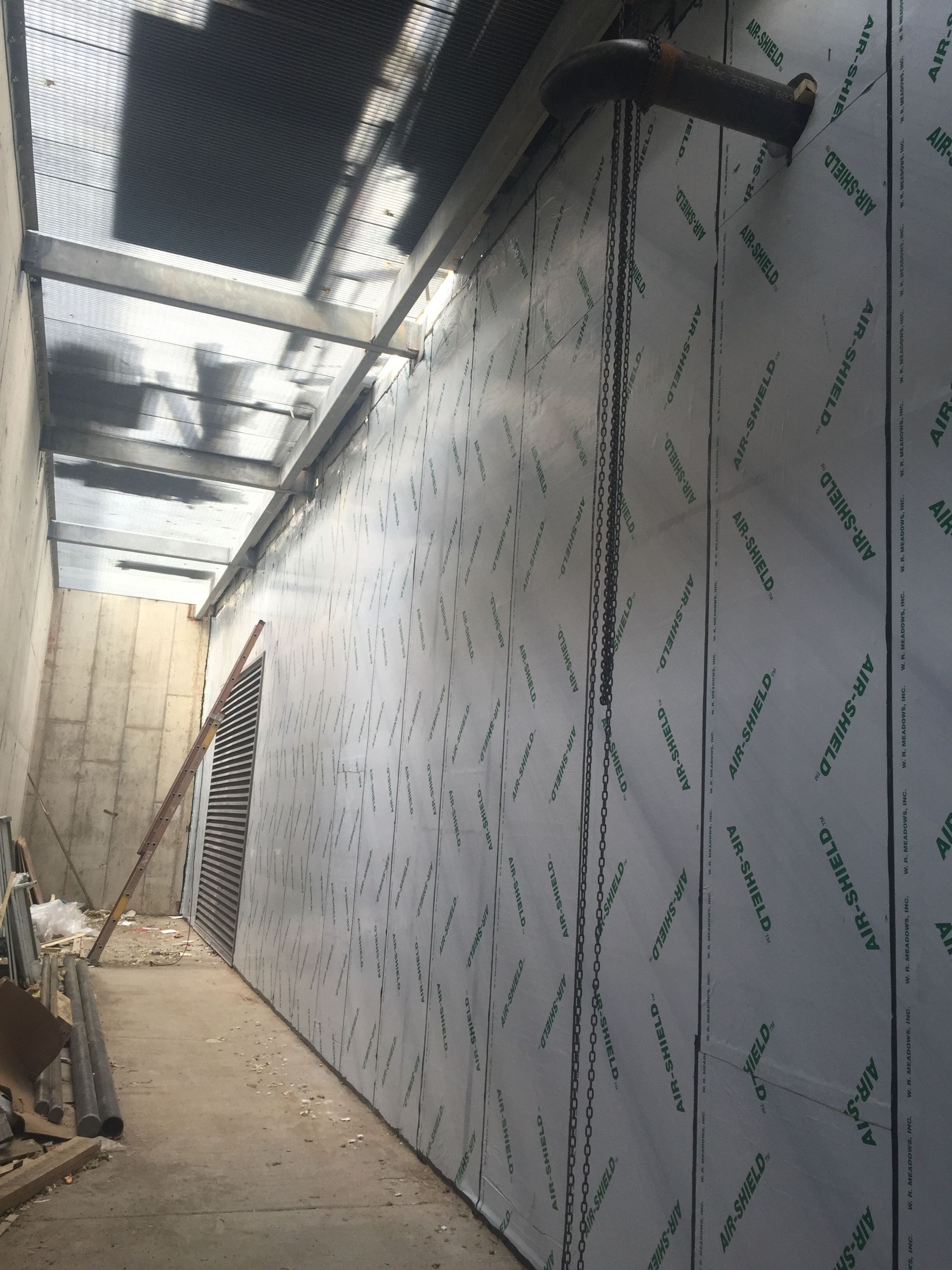 With his company in charge of installing the air and water vapor barrier, Scrivner noticed a problem with the exterior Sheetrock drywalls ability to hold the primer.