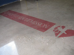 Logo for the Charlotte Rescue Mission dyed onto the concrete slab an polished.