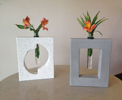 Concrete flower vase holders. Holds glass cylinders. 