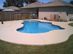 Before and after pool deck restoration.This residential project in Rancho Cucamonga, Calif., included a complete restoration of the rock pool and spa. Kevin Brown of KB Concrete Staining, Mira Loma, Calif., used NewLook materials for the renovation, including the companys SmartColor stain in Milk Chocolate, White, Black and a tan shade.  Photo courtesy of Kevin Brown, KB Concrete Staining