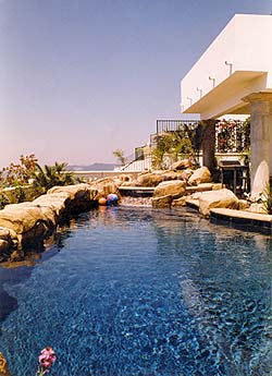 Richard Smith Custom Concrete created a faux rock surrounding a swimming pool on a cliff.