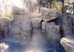 Richard Smith Custom Concrete's awesome concrete rock waterfall spilling into a fun filled swimming pool.