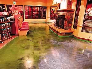 Polished concrete with concrete dye in green has been sealer using the correct concrete sealer for a busy market floor.