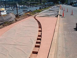 Bandon Boardwalk Construction - The two sides of the walkway were also doweled together, to keep one half from settling below the other over time. After both sides were finished, the entire concrete surface was coated with an acrylic sealer.