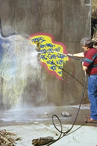 Removing graffiti with a pressure washer after the proper coating was placed on the concrete.