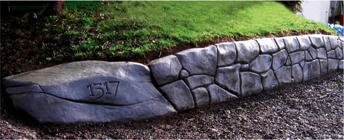 Faux Rock wall by Eric Dahl - The use of fiber reinforcement in shotcrete for faux rocks appears to be a personal choice. Some feel it adds strength. Others dont. Some say the fibers can look like fuzz on the surface if they are disturbed during the detailing stage.
