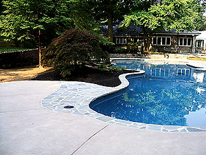 Pool Decks Photo courtesy of Architectural Concrete Design. "The American Concrete Institute (ACI) says a gravel base is not necessary. You just need a stable base. In Georgia they pour on clay. In the North we use gravel as a thermal stabilizer  it is an insulator on expansive soil. You can pour right on stable sand too.