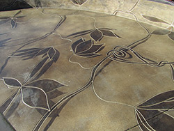 Engrave the edge of acid stain design into concrete to give a definite edge to the design.