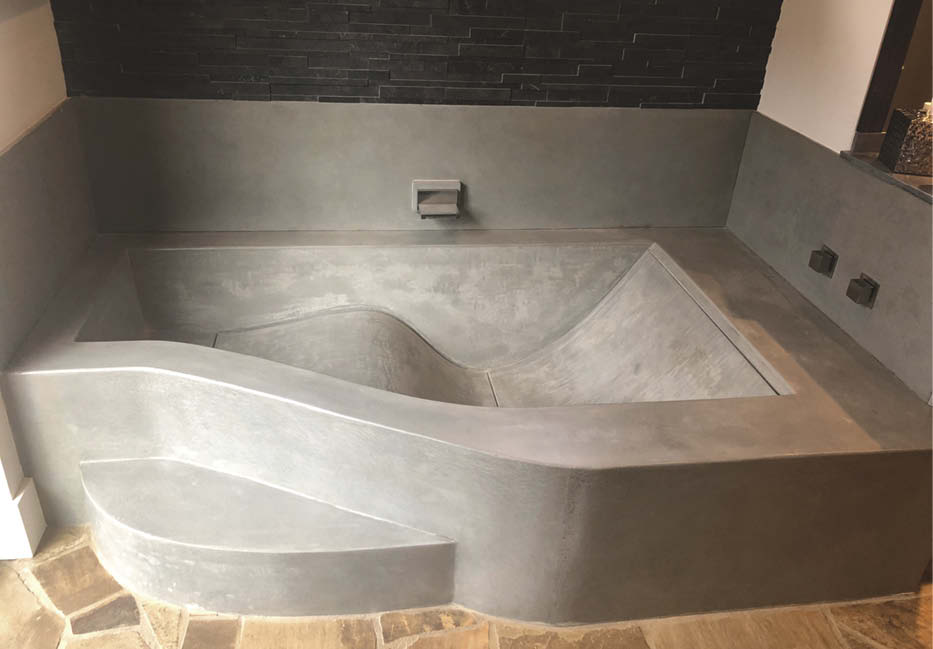 Concrete bathtub with ergonomic tub.