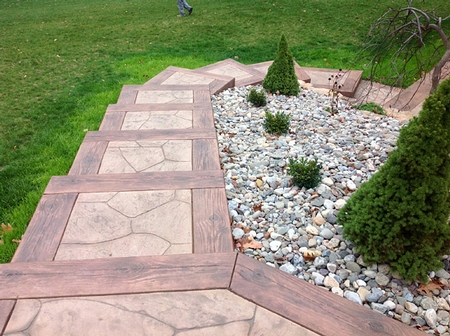 Stamped concrete steps make it easier to traverse down this steep backyard hill.