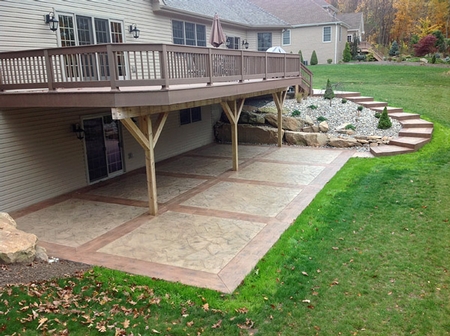 Concrete patio with stamped and stained concrete and red borders.