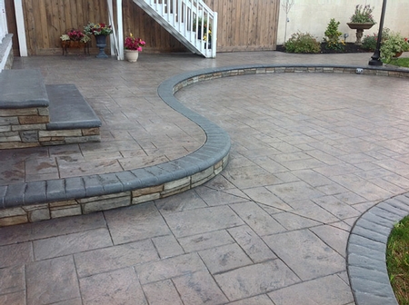 Stamped concrete patio with a curved step.