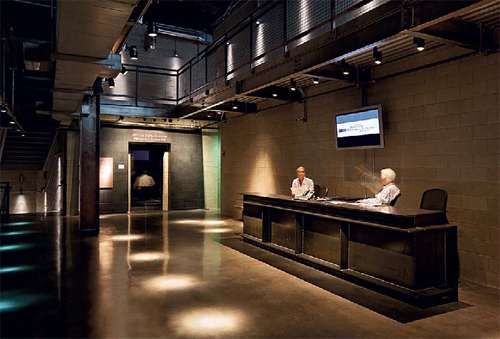 CMU walls and polished concrete floors dominate the museum's point of entry for tours.