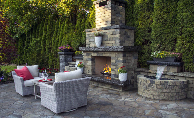 Outdoor concrete patio with a fire feature.