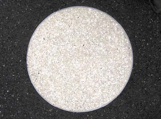 A close up of a full moon that has been rendered in the concrete.
