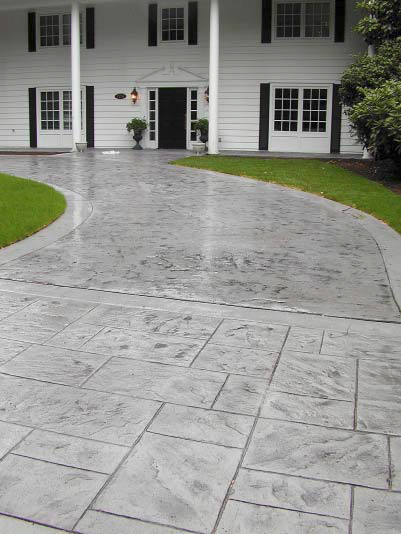 Stamped and sealed concrete driveway brings the guests to this mansion right to the front door.
