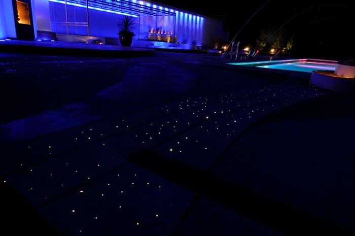 The pool area with all of its design features operational, including fiber optic lighting. A privacy wall at the house was built out of empty shipping containers.