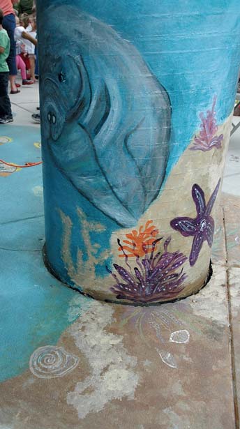 Ocean scene on a concrete post using water based acid stains.