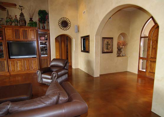 Stained concrete living room with dark brown leather furniture.