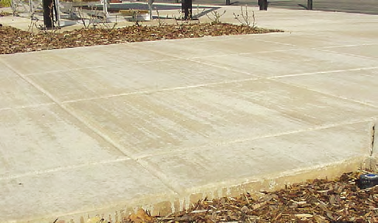 Using excess water will lighten and discolor integrally colored concrete. This is especially true if water is used during the finishing process, which resulted in broom marks and streaks on this concrete slab.