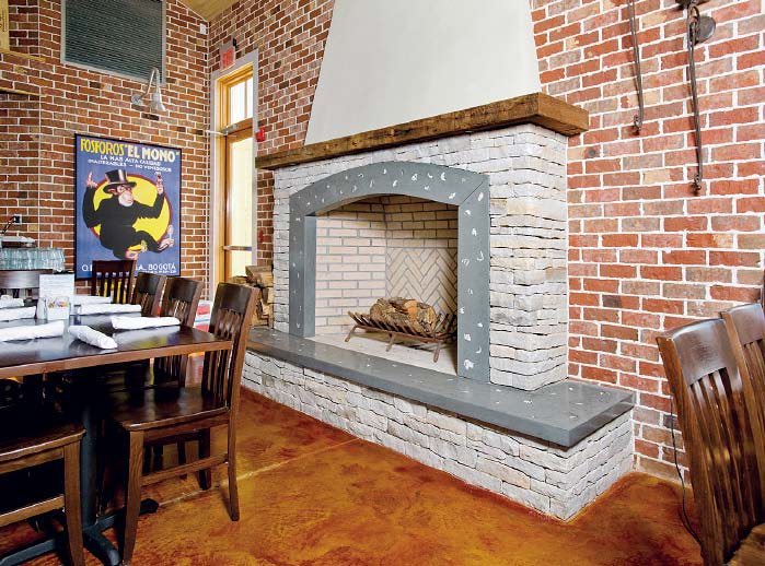 A faux brick fireplace that has been stamped, stenciled and carved for the desired old-world look.