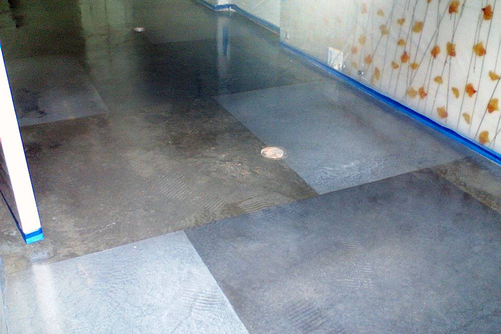 Using Tape with Decorative Concrete Overlays can ensure quality work every time like the tape seen here on the concrete floor.