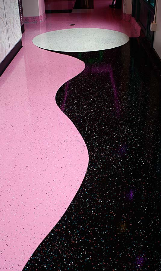 Black, Pink, and white epoxy checkerboards and playful curves that complemented the surrounding theme.