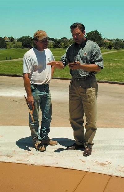 Concrete contractor using sales and marketing techniques to talk to customer about the benefits of using decorative concrete around their home.