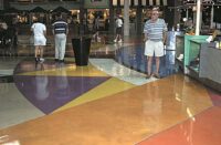 Mesmerizing water based stained concrete floor with geometric styling in a shopping center food court.