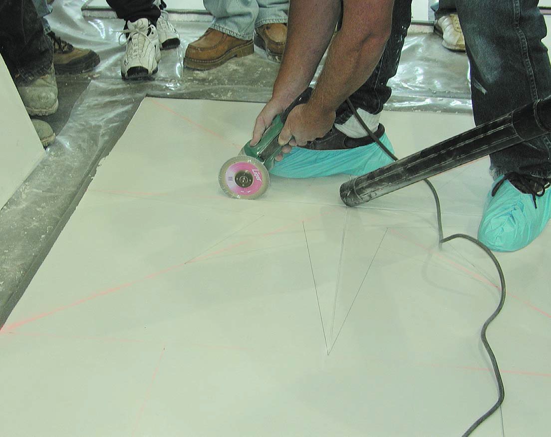 Keeping your workspace clean is vital when engraving concrete, by using vacuums to follow the engraving tool.