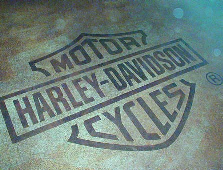 Popular brand, Harley Davidson Cycles logo was engraved on a simple gray background.