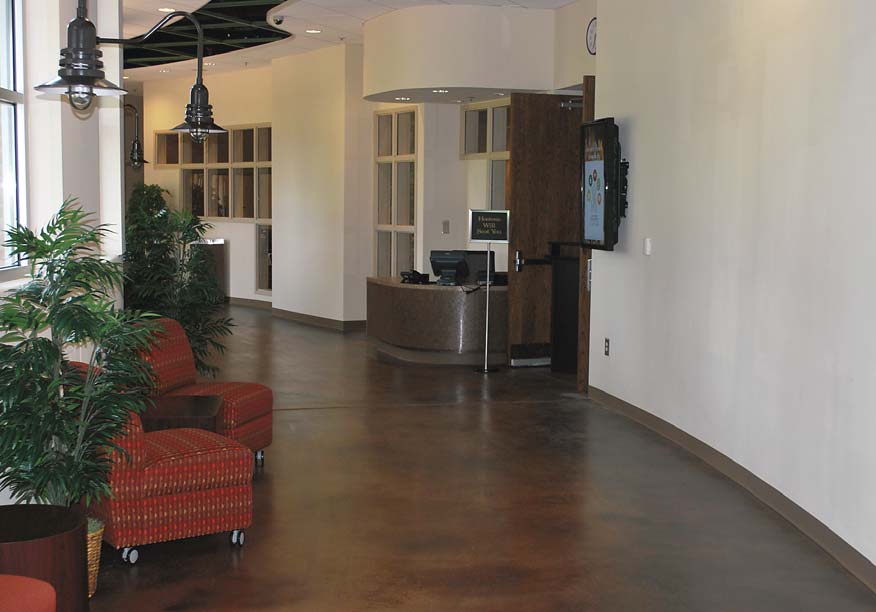 A burnished concrete floor with Smiths Color Floor water-based stain in Bark Brown and Dark Brown, Smiths Base Boost and Smiths Surface Guard.