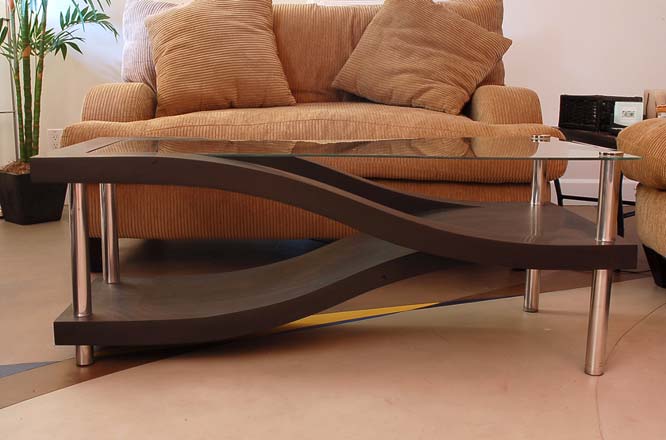 Concrete coffee table with a glass top and elegant angles.