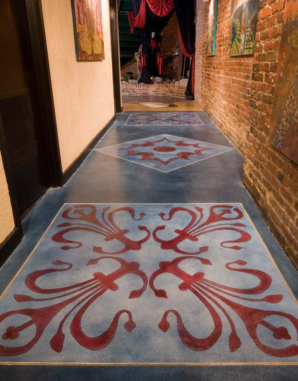Hallway with a concrete overlay that was saw cut and colored using blue and dark red.