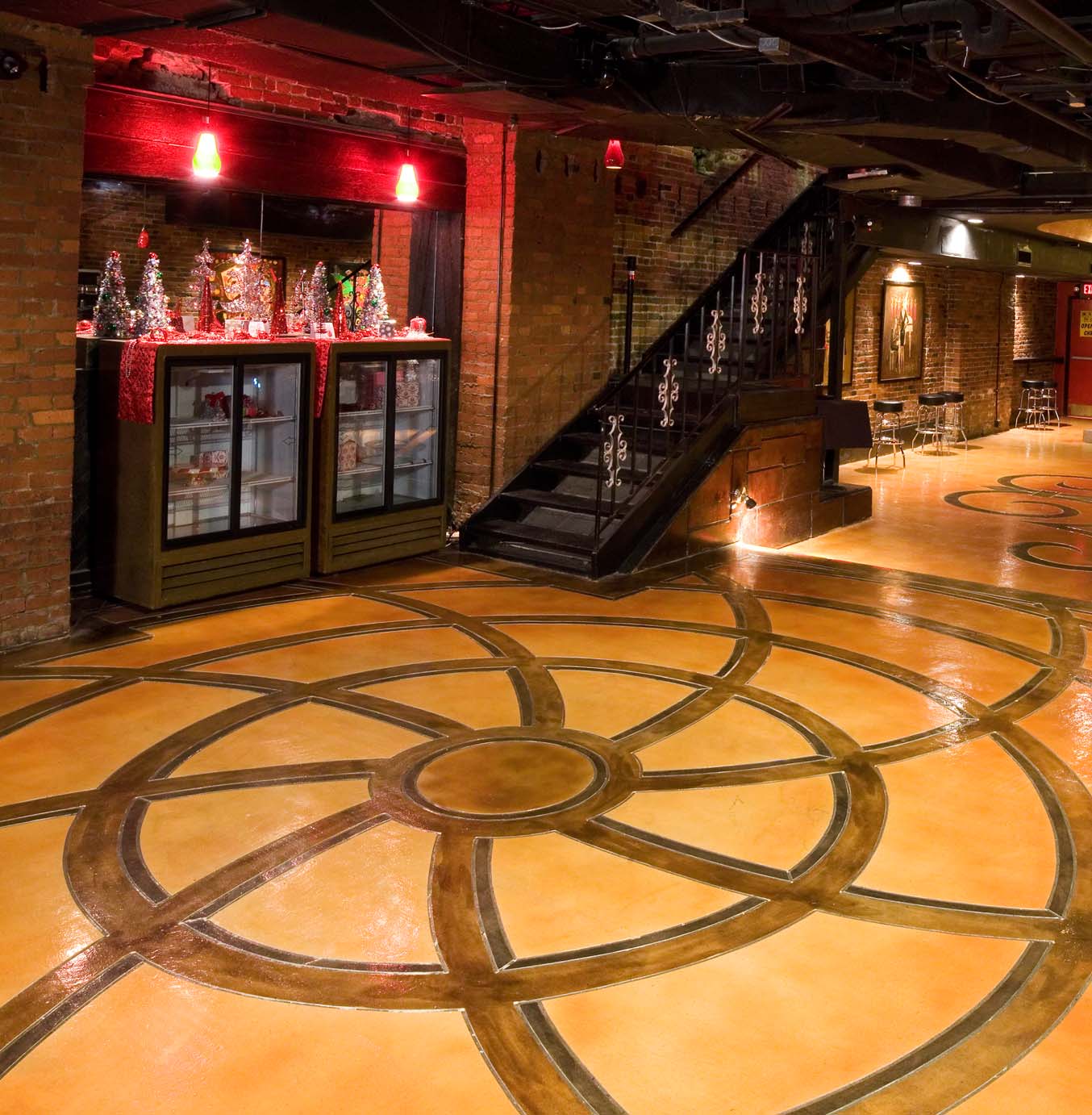 Spiral design on concrete overlay browns and light tan in Nashville.