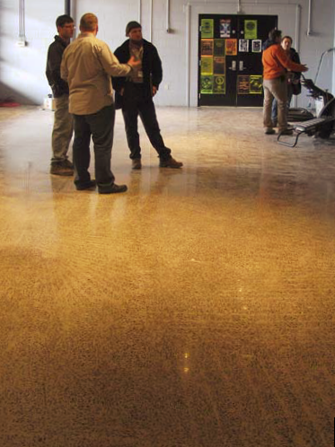 Show attendees standing on the freshly polished concrete floor.