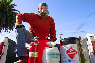 I now dress appropriately when spraying flammable solvents: long-sleeved shirt and pants, and headscarf, in natural fibers; respirator and goggles; leather boots and gloves. Theres a bucket and rag in case the hose bursts and an appropriate fire extinguisher and water hose with a trigger nozzle.