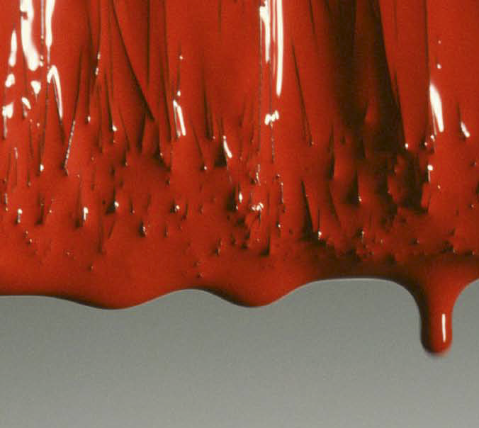 A red paint brush dripping paint.