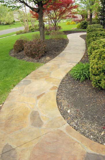 A pathway that has been stamped and stained to look like natural stone.