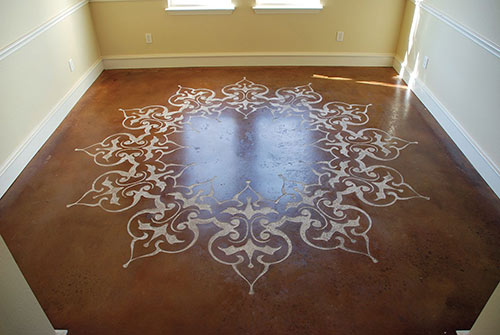 Stenciled, sand blasted and stained concrete in a dining room.