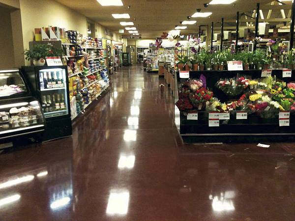 Grocery store with red polished concrete in the produce section.