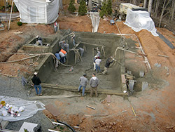 Workers installed 80 yards of shotcrete when constructing the pool prior to using stamped concrete to complete a Hidden Oasis by Greystone Masonry.